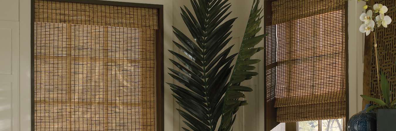 Brown woven shades on windows in a living room