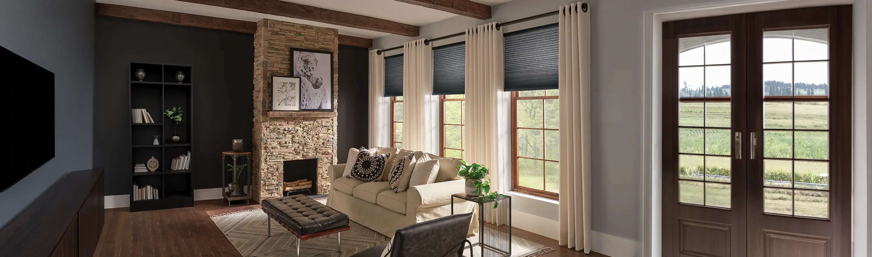 cream color draperies over cell shades on three large tall windows in a rustic living room area