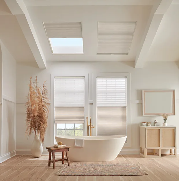 White cellular shades on skylights in a teal home office