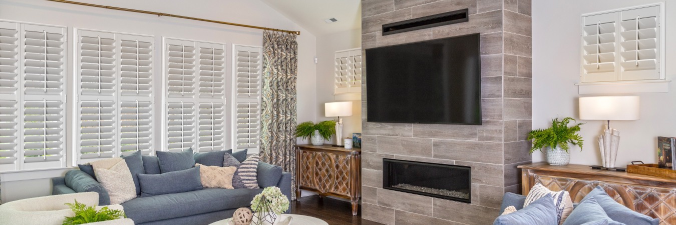 Plantation shutters in Pine Valley family room with fireplace