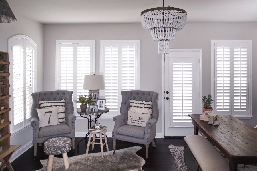 White interior shutters in a modern farmhouse living room.