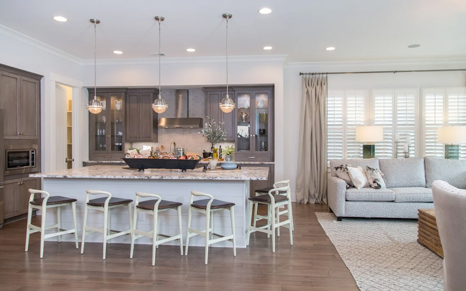 Illuminate your home with custom interior shutters in St. George. White arched shutters in a white kitchen with lots of light.