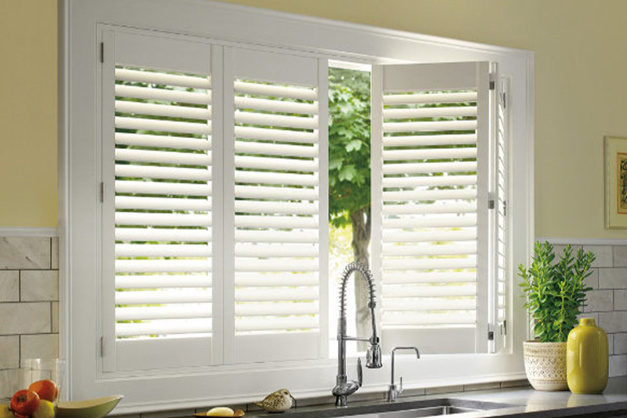 White Polywood shutters above a kitchen sink.