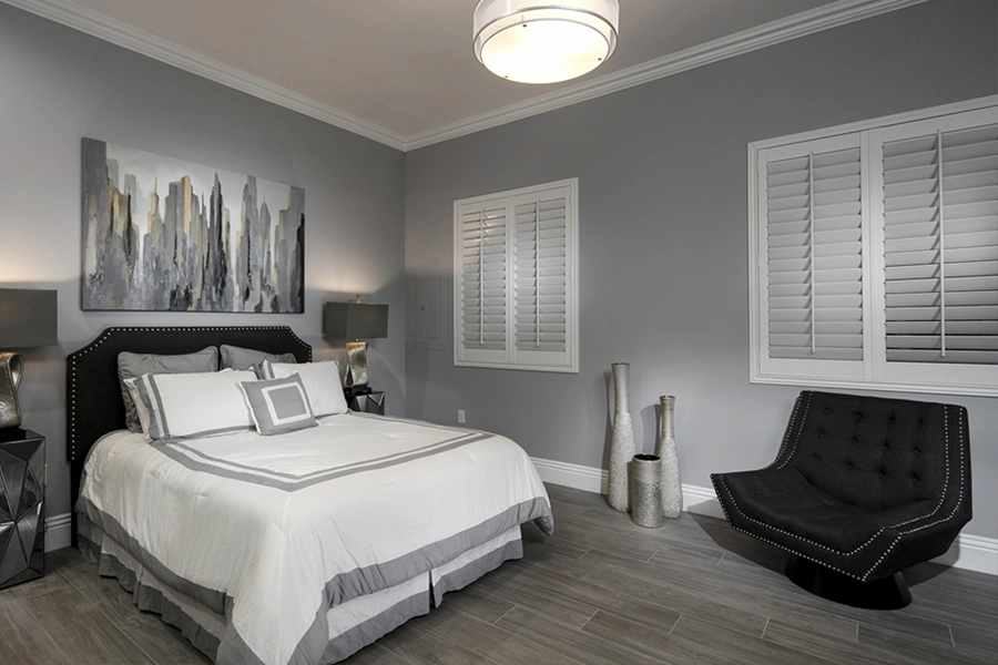 Close your custom Polywood shutters to beat the heat and keep your St. George bedroom cool. White Polywood shutters on bedroom windows
