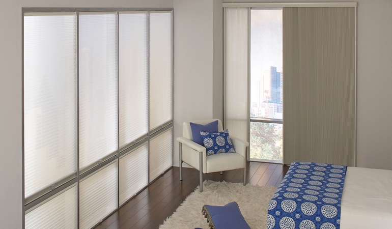 Cell shades are another option to support a minimalist design. Cellular shades in a streamlined bedroom.