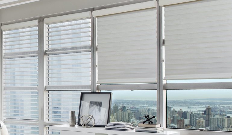 Sheer plantation shutters contain soft dual fabric panels that provide the ultimate light control. Sheer shade in a high rise apartment