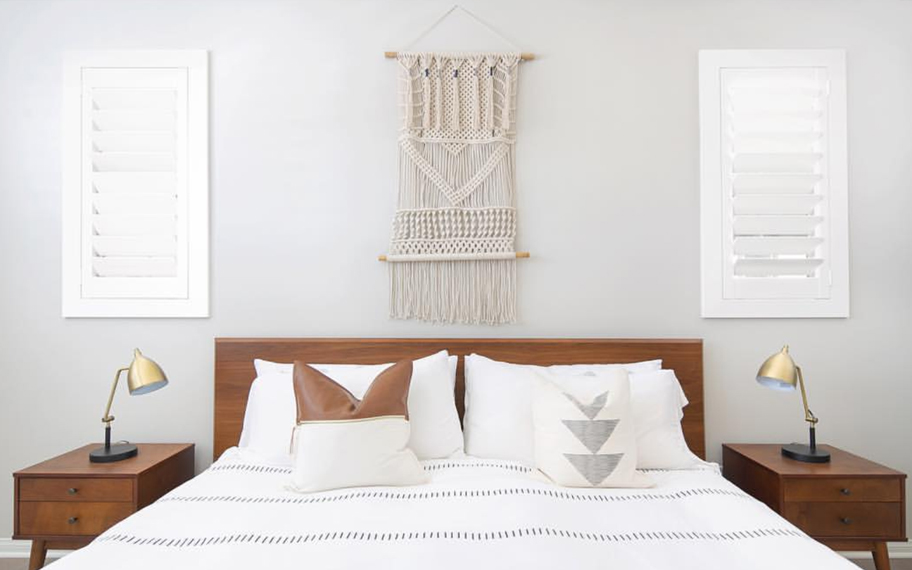 Custom-fitted louvered shutters provide excellent nighttime privacy in St. George. Photo Credit: Audrey Crisp Louvered shutters in a bedroom.