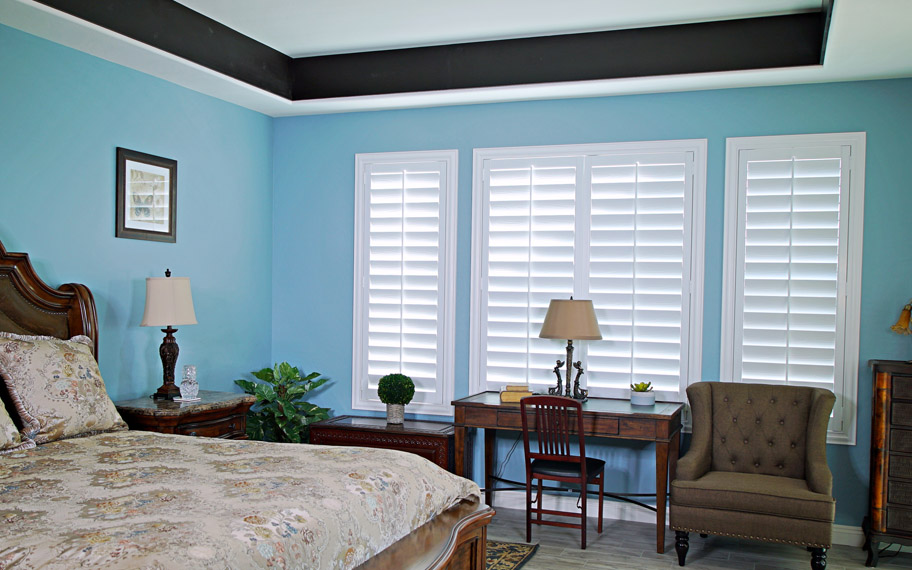 Polywood shutters provide insulation for the perfect temperature all year long in St. George. Polywood shutters in a bedroom.