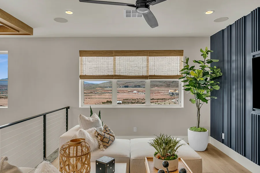 St. George homeowners who want eco-friendly home fixtures should consider natural woven shades. Natural brown woven shades on a window in a stylish sitting area