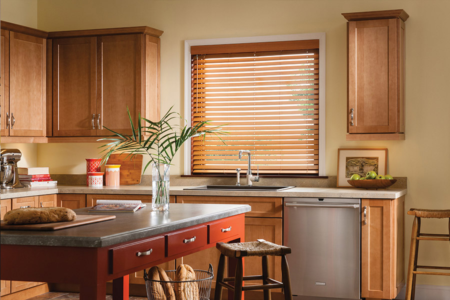 Waterproof faux wood blinds are durable and give you privacy and light control in your St. George kitchen. Dark faux wood blinds above a kitchen sink
