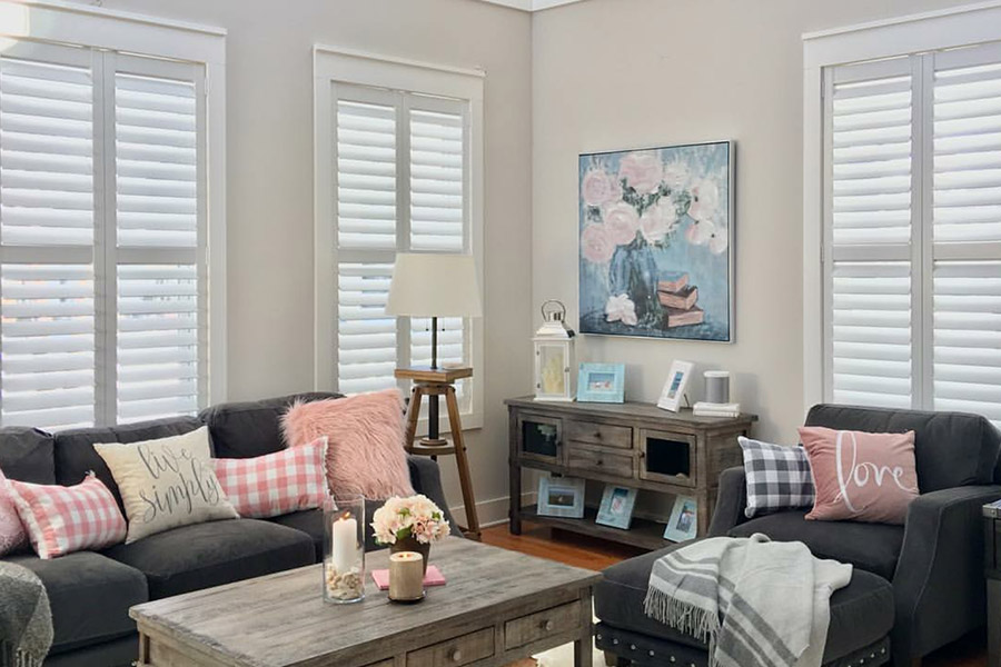 White Polywood shutters lend themselves to all kinds of living room decor. White Polywood shutters on living room windows